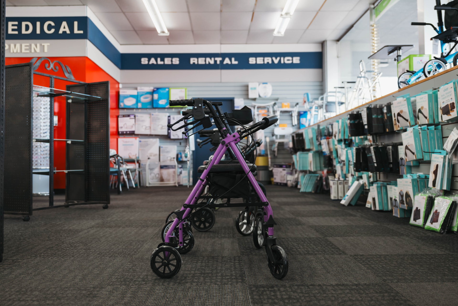 Purple rollator walker in the durable medical equipment showroom at Hart Pharmacy