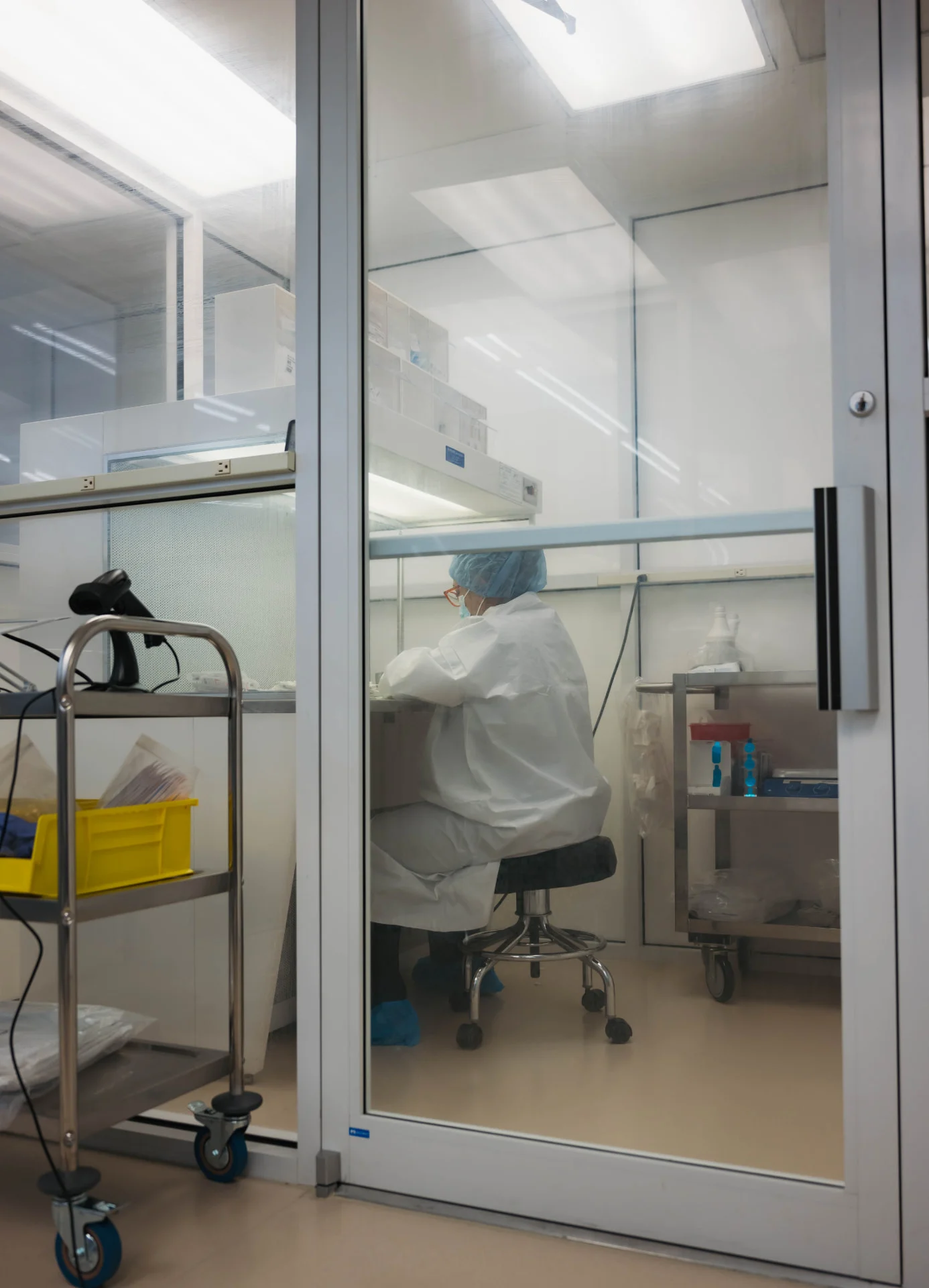 Pharmacist in sterile garb preparing a compound inside the Hart Pharmacy clean room