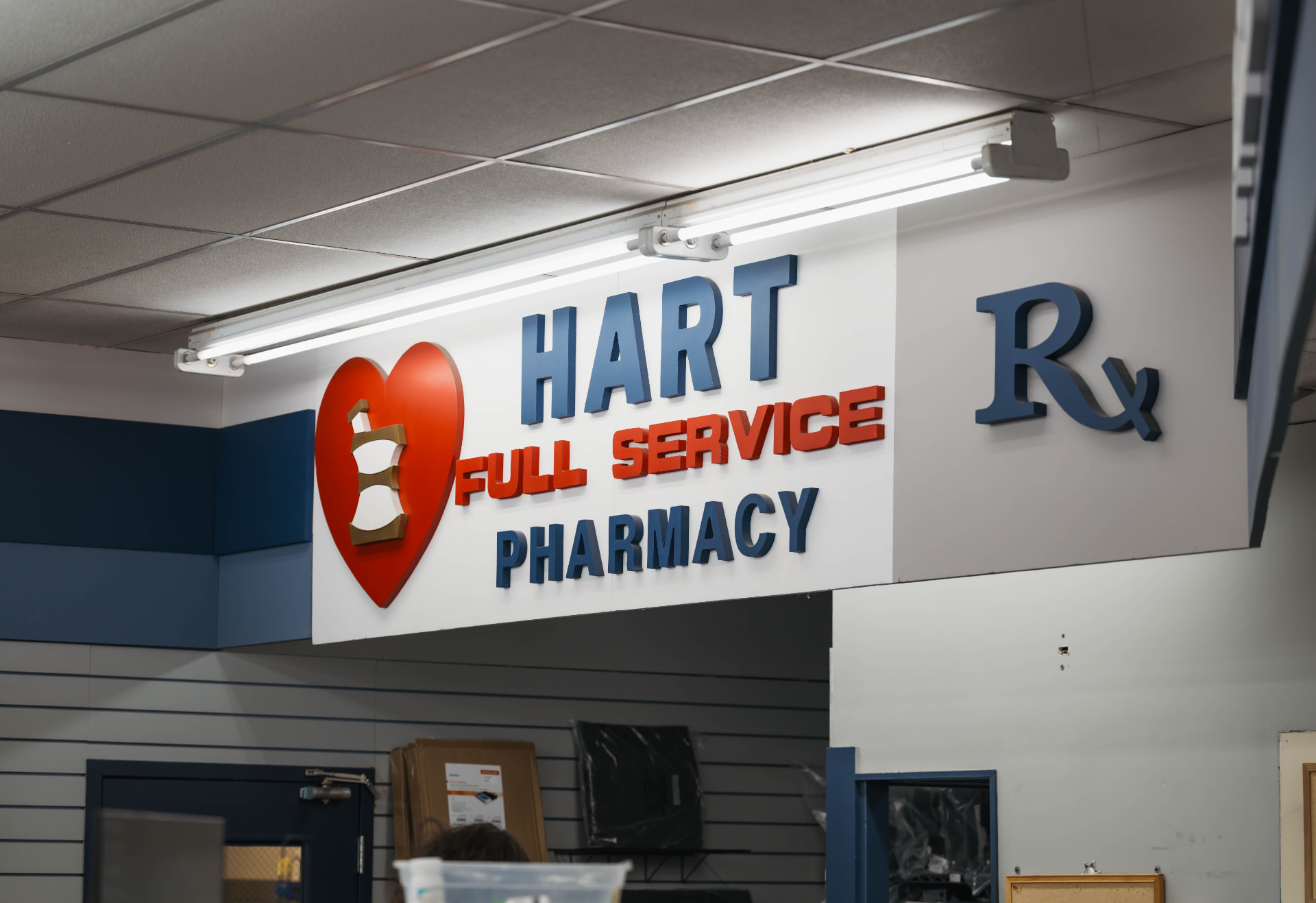 Hart Full Service Pharmacy sign above the prescription counter