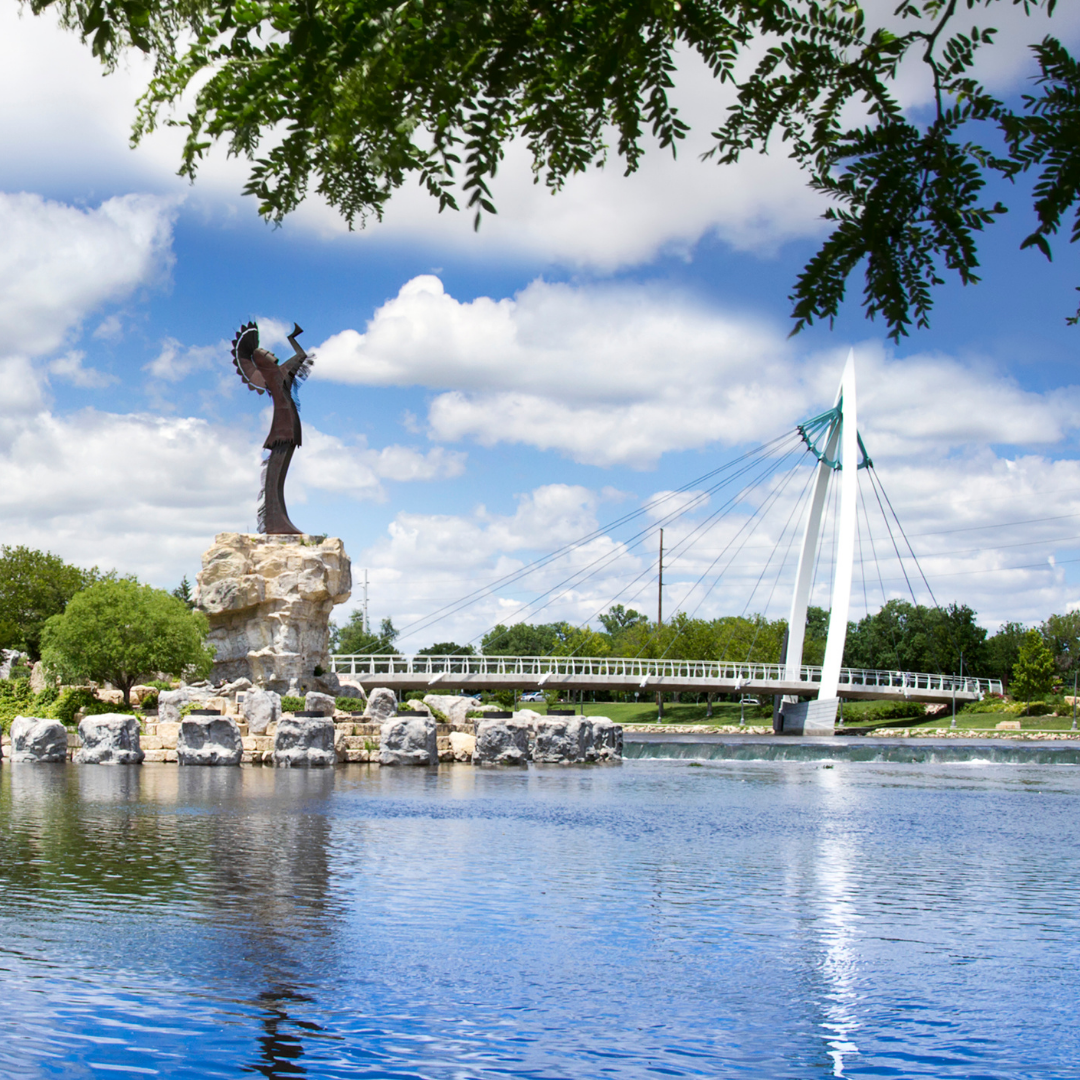 Keeper of the Plains statue on the Wichita, Kansas riverfront, with the walking bridge over the Arkansas River